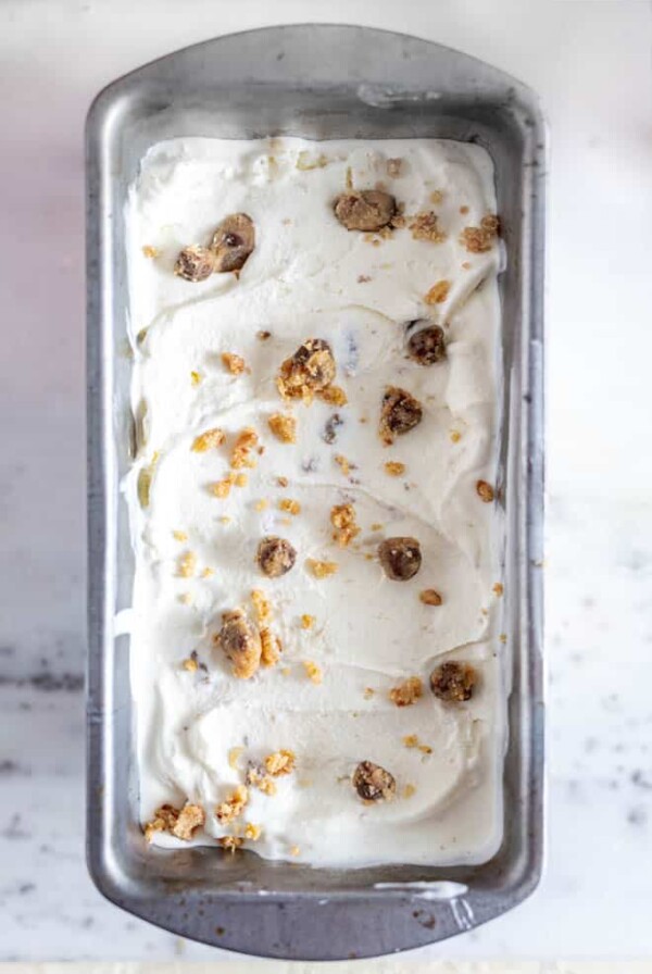 cookie dough ice cream in a bread loaf pan with chunks of cookie dough sprinkled on top