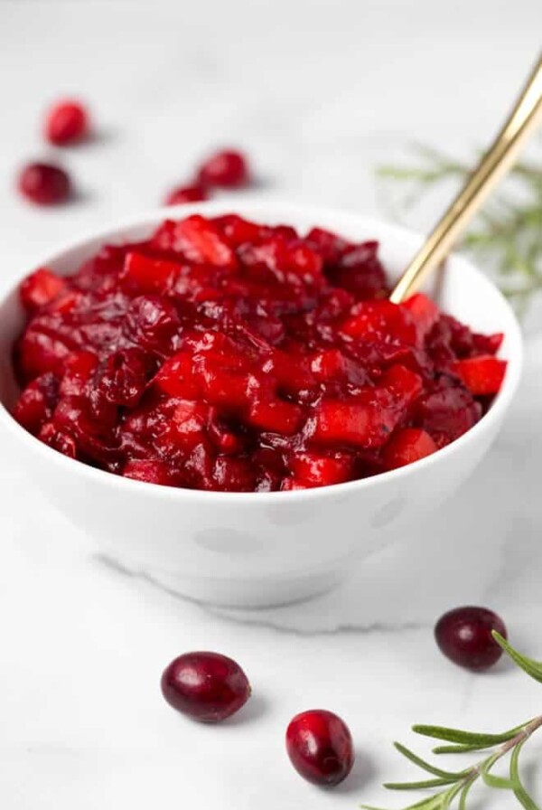 Combine a few simple ingredients in a saucepan to make this homemade apple cranberry sauce with orange and ginger! It's packed with flavor and is paleo and naturally gluten free. #apple #cranberry #sauce #orange #ginger #recipe #healthy #thanksgiving #sidedish #homemade