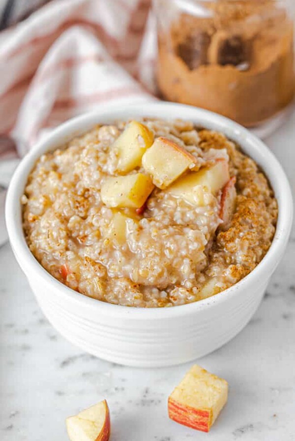 apple steel cut oatmeal in a bow with chopped apples on top