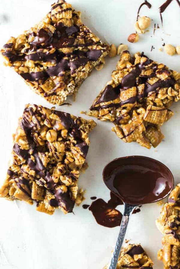 Three cereal bars drizzled with chocolate.