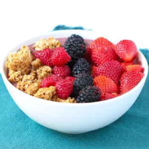 A acai bowl with strawberries, blackberries, raspberries and granola.