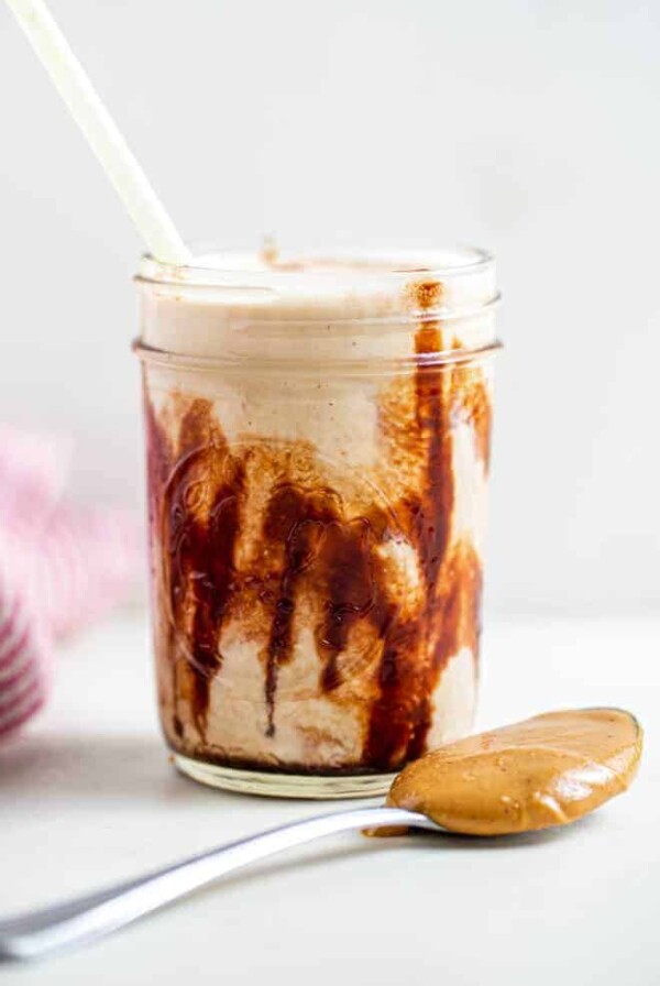 Glass mug with peanut butter smoothie.