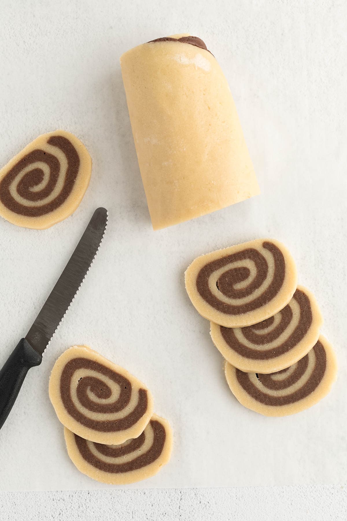 The cookie dough sliced into 1/4-inch cookies before baking. 