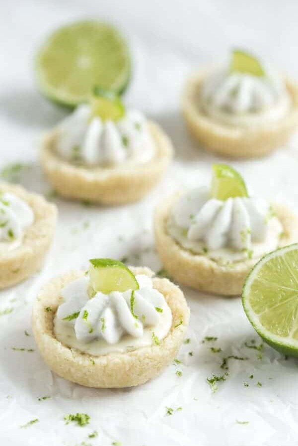 No Bake Mini Key Lime Pies - a layer of crust is filled with key lime filling and topped with whipped coconut cream! These little bites pies are gluten free, vegan, paleo and healthy!