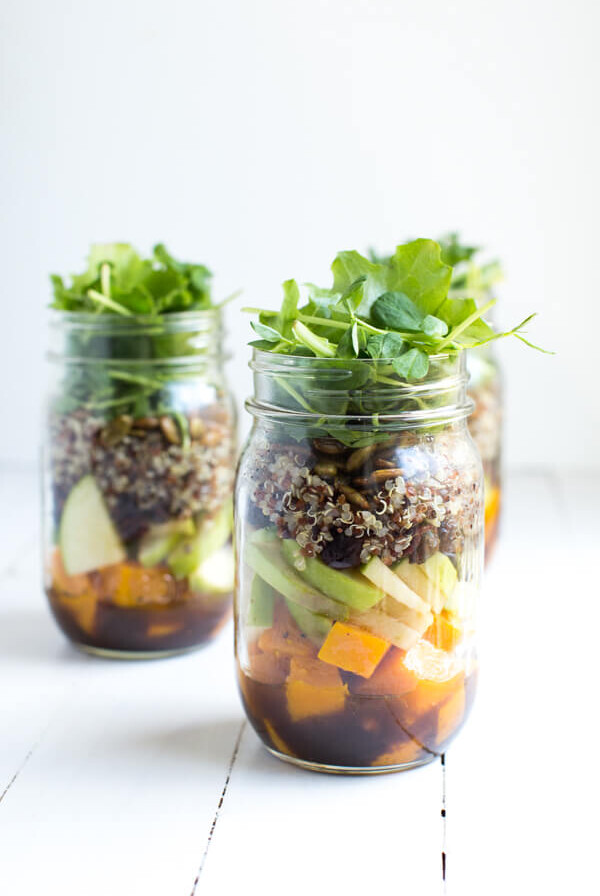 Fall Mason Jar Salad with Maple Balsamic Dressing includes roasted butternut squash, apples, dried cranberries, quinoa, toasted pumpkin seeds, and fresh greens!