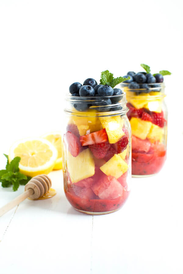 Mason Jar Fruit Salad with Strawberry Mint Dressing is made with the freshest flavors piled high in a mason jar. Kids and adults will love it!