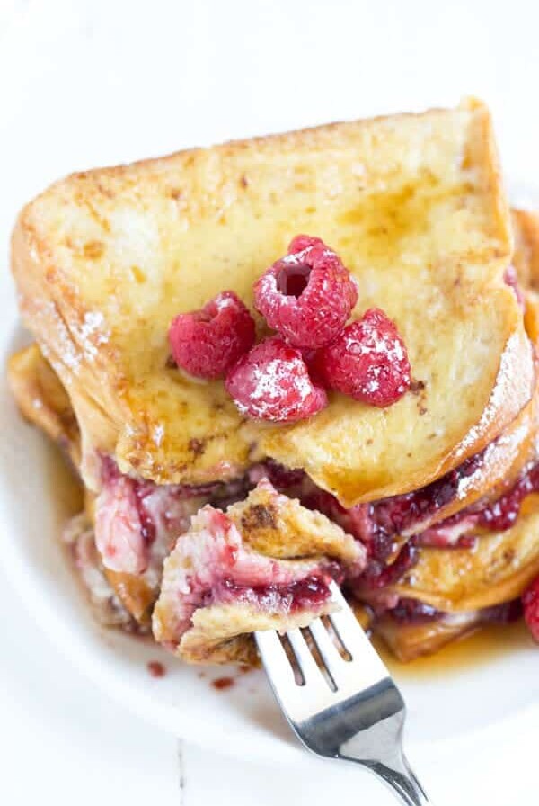 Raspberry Cheesecake Stuffed Brioche French Toast is a great idea for breakfast or brunch. With sweet raspberry amaretto preserves and cheesecake filling, this buttery french toast is too good to resist!