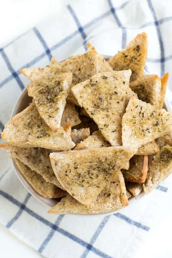 A large bowl of baked seasoned pita chips.