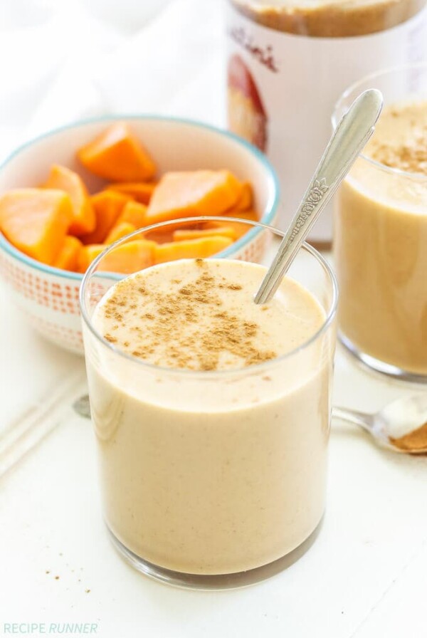 one glass of sweet potato smoothie with a bowl of chopped sweet potatoes next to it