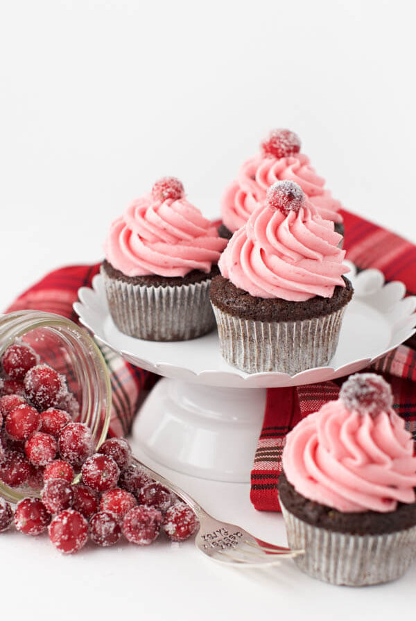 Gingerbread cupcakes with cranberry buttercream frosting combine two of your favorite holiday flavors in one sweet treat that is sure to impress!