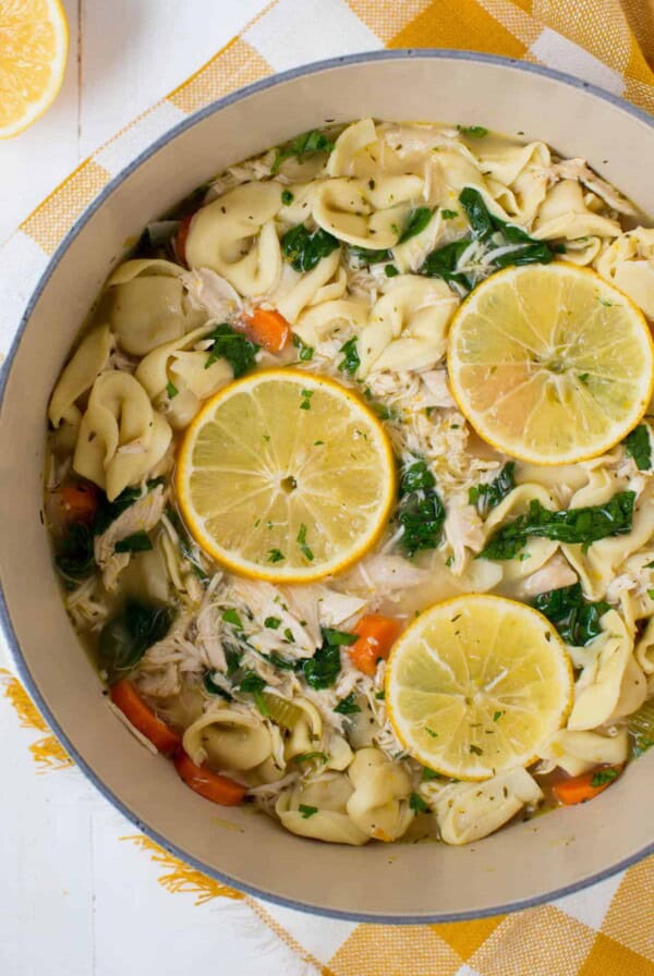 a pot filled with cooked chicken tortellini soup with spinach