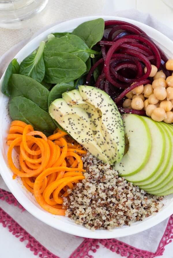 Harvest Buddha Bowl with Lemon Tahini Dressing is made with fresh spiralized beet and sweet potato noodles, spiralized apple, chickpeas, spinach and more! Pack this bowl for lunch to fuel up for the day.