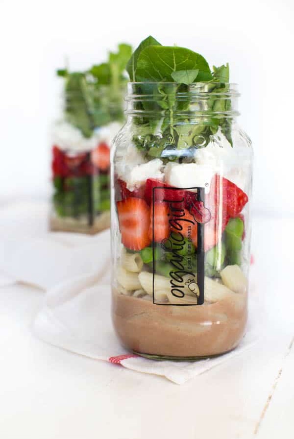 Six ingredients are layered in a mason jar to create a fresh and flavorful Spring Green Mason Jar Salad with Strawberries! Pack the mason jar for on-the-go or enjoy an easy lunch at home.