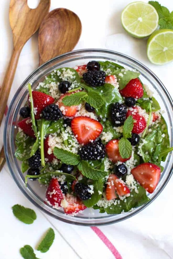 Triple Berry Couscous Salad with Honey Lime Mint Dressing combines couscous with fresh spinach, strawberries, blueberries and blackberries. Drizzle the homemade honey lime mint dressing over the salad to create a light and flavorful addition to any meal!