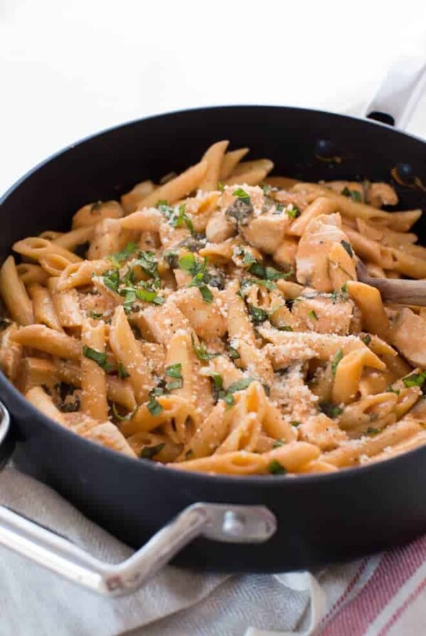 One Pot Creamy Tomato Pasta with Chicken and Spinach comes together in 35 minutes! The entire meal cooks in one pot and creates a dish that kids and adults love.