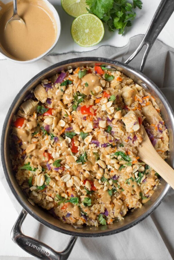 Thai Chicken Peanut Rice Skillet is an easy one pot meal that cooks in less than 30 minutes! It's packed with red bell peppers, carrots, cabbage, baby bok choy, chicken, rice and a creamy peanut sauce. #chicken #peanut #skillet #dinner #weeknight #meal