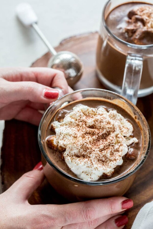 Homemade hot chocolate is the perfect sweet treat and drink to celebrate the holidays! This recipe cooks in the Instant Pot or Slow Cooker to make things easy for holiday entertaining. #instantpot #slowcooker #homemade #hotchocolate #recipe