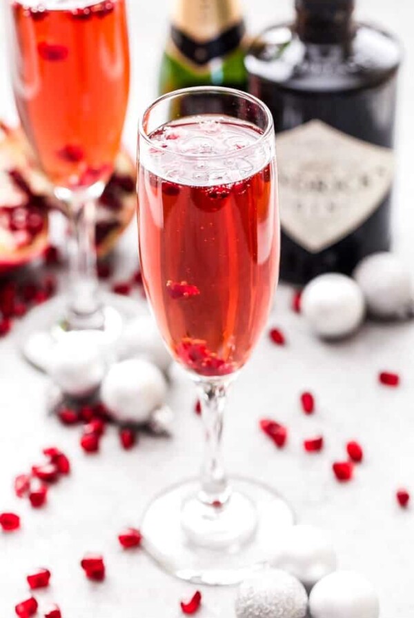 Pomegranate French 75 is the perfect drink to add to toast with this holiday season and a must for brunch! Bubbly, sweet and floral with a touch of tart flavor from the pomegranate. #French75 #pomegranate #cocktail #champagne #christmas #newyearseve #valentinesday #brunch