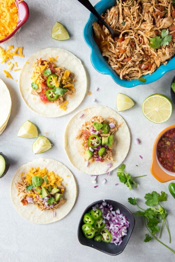 Slow Cooker Shredded Chicken Tacos are made with only a few ingredients and cook in your crockpot. It's the perfect meal for any day of the week! #slowcooker #chicken #tacos #recipe #weeknight #meal #dinner #crockpot