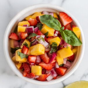 Overhead view of a small bowl of strawberry mango salsa