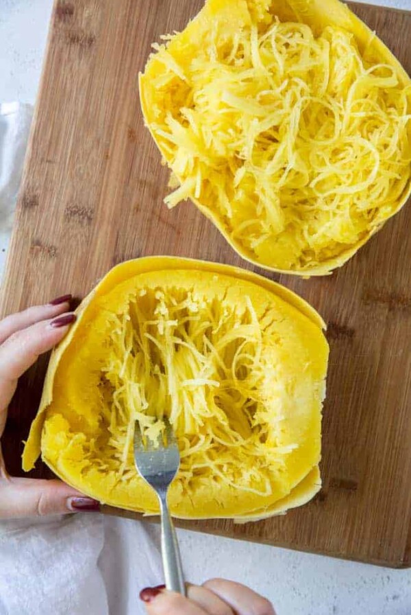 scooping out spaghetti squash