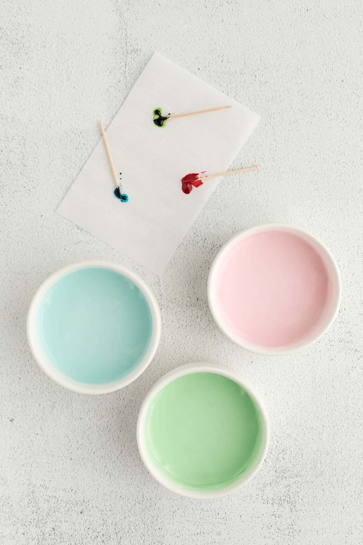 Three icing colors in bowls ready to use for decorating. 