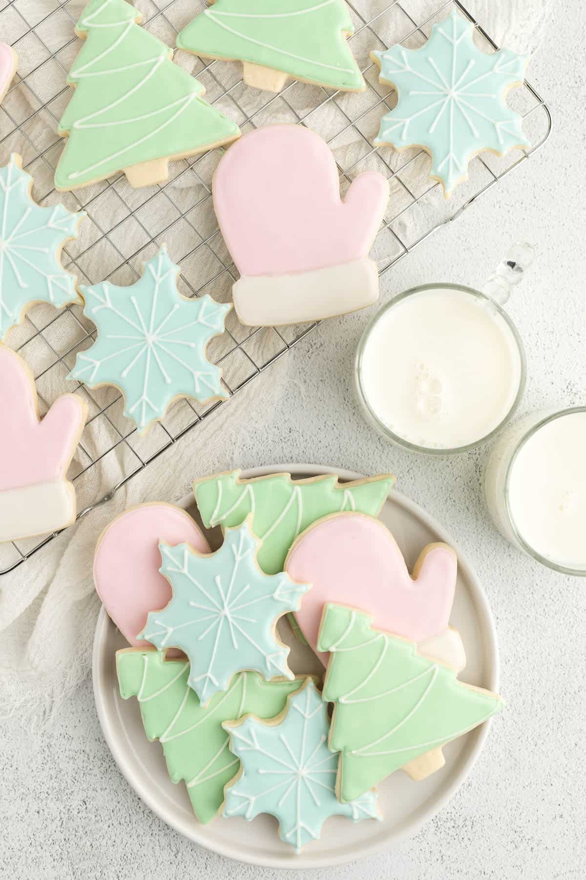 Sugar cookies with royal icing on a plate and baking rack.