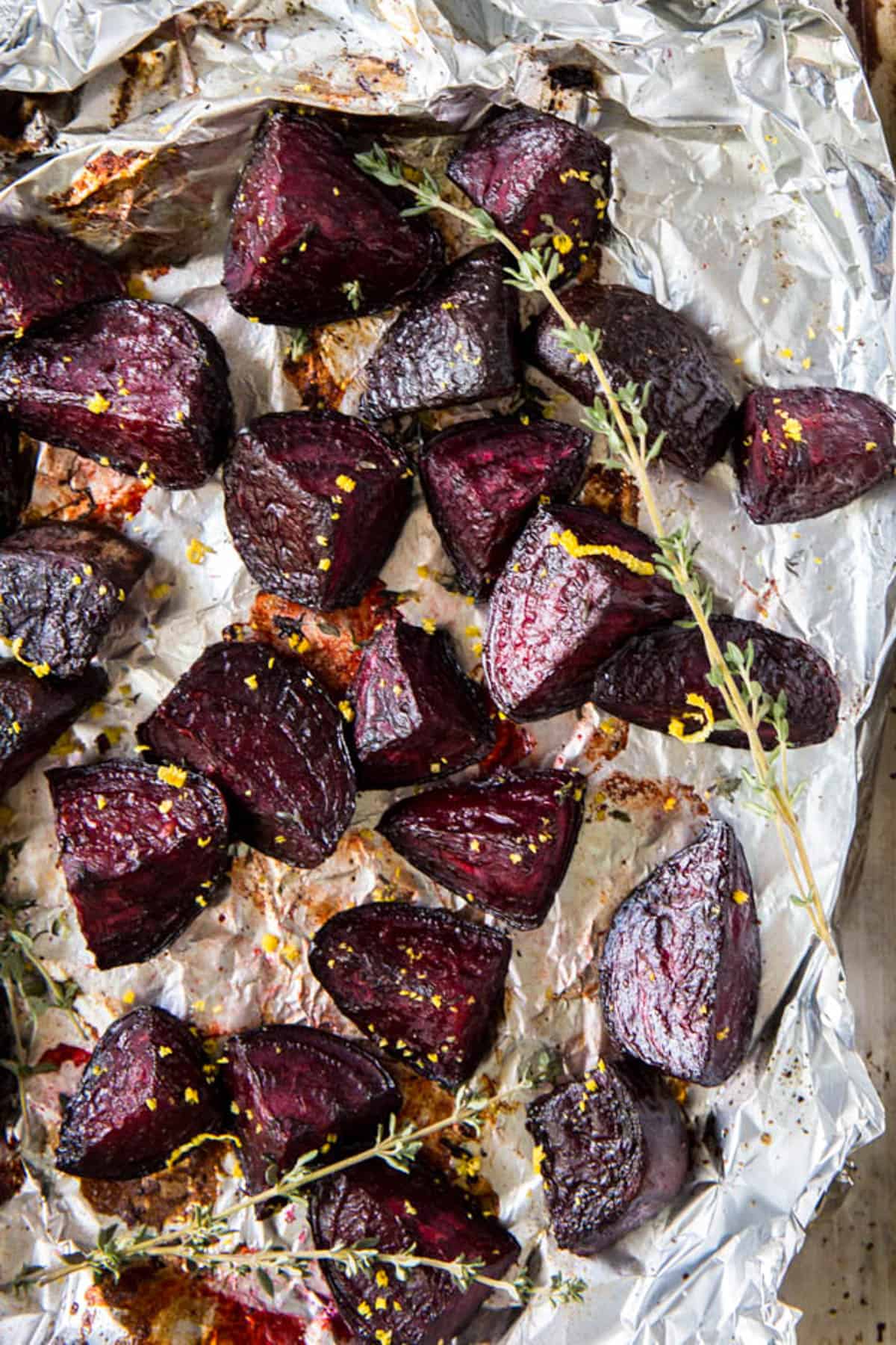 Oven roasted beets on a baking sheet after baking in the oven. 