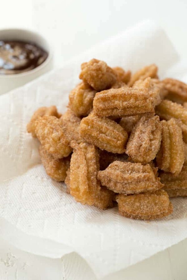 a pile of mini churro bites sitting on a plate