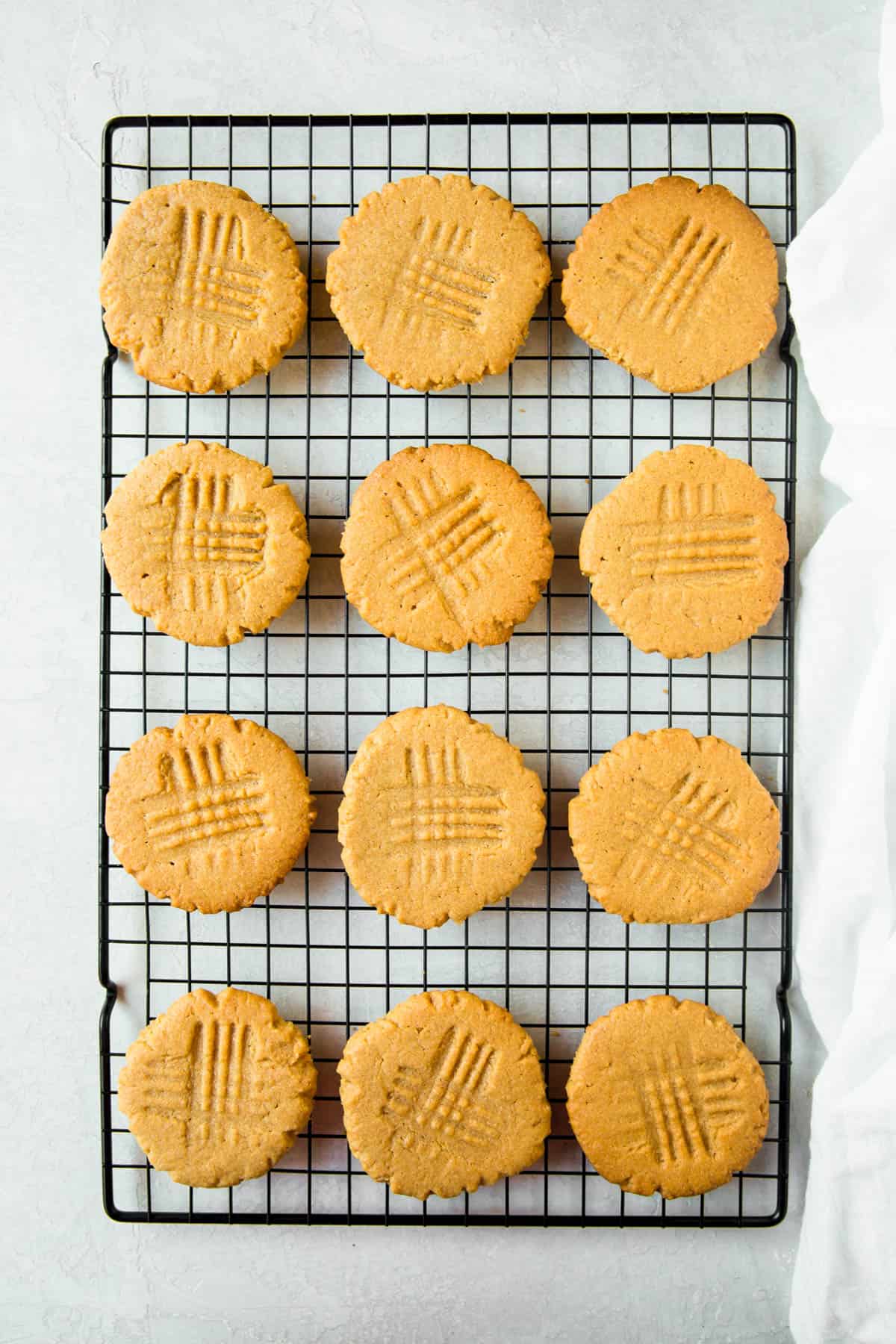 Fresh out of the oven peanut butter cookies on a wire rack.