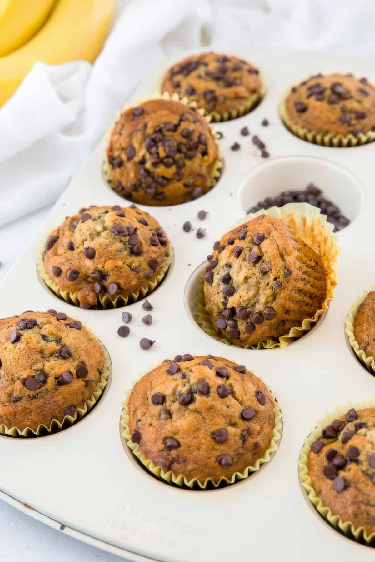 a muffin pan filled with baked banana chocolate chip muffins