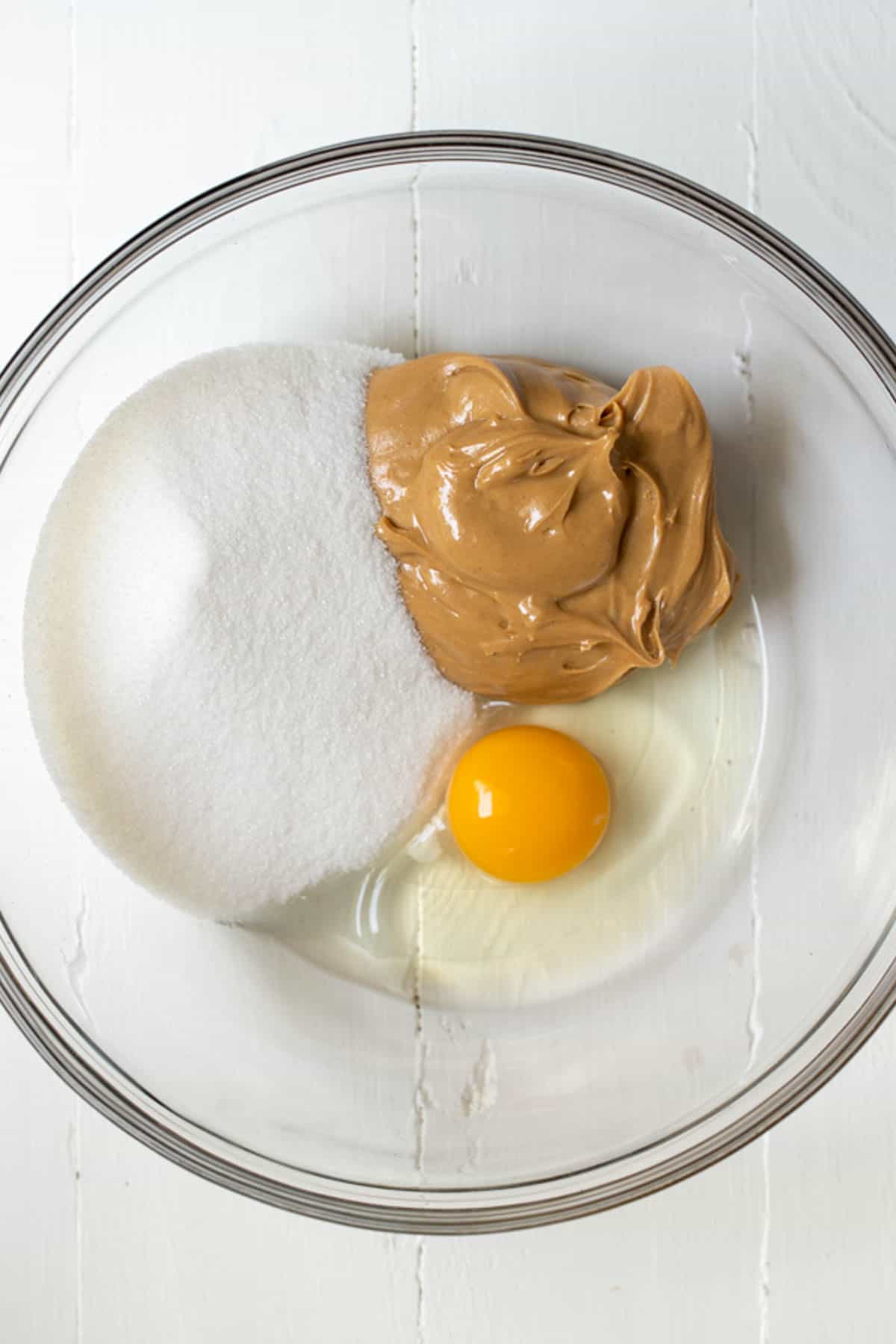 A cup of sugar, a cup of peanut butter, and an egg.