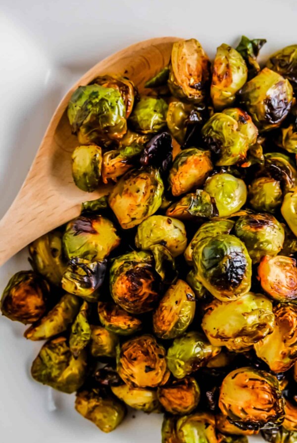 a white plate filled with roasted brussels sprouts