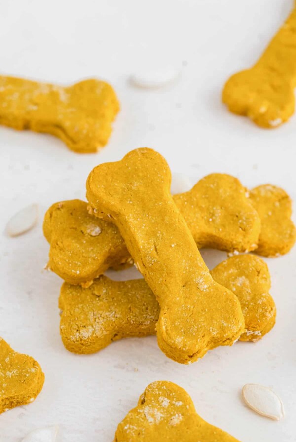 a stack of homemade dog treats on a white table