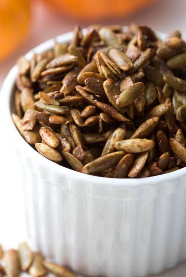 a white bowl filled with roasted pepitas