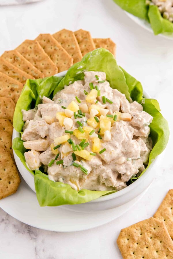 a bowl filled with hawaiian chicken salad with crackers