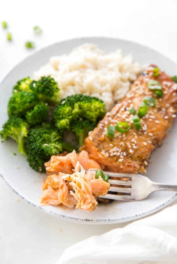 A plate with flaky teriyaki salmon, rice and broccoli