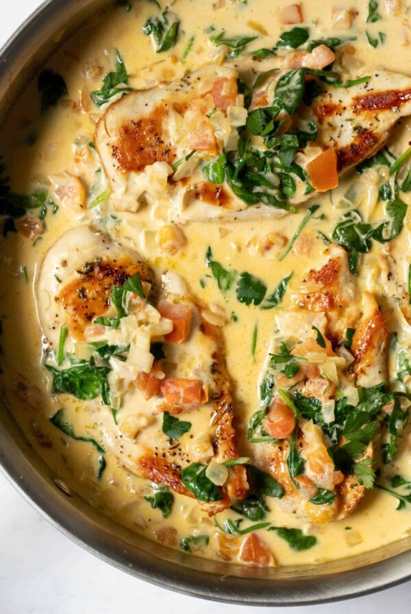 tuscan garlic chicken in a skillet with creamy sauce