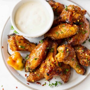 Aerial view of a plate of wings with a dish of blue cheese