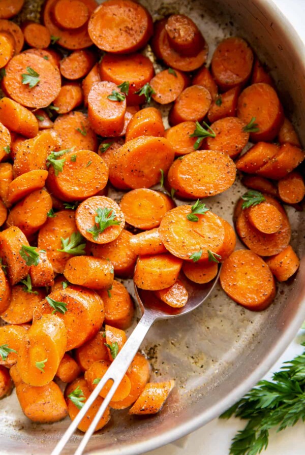 Carrots being sauteed with olive oil and parsley