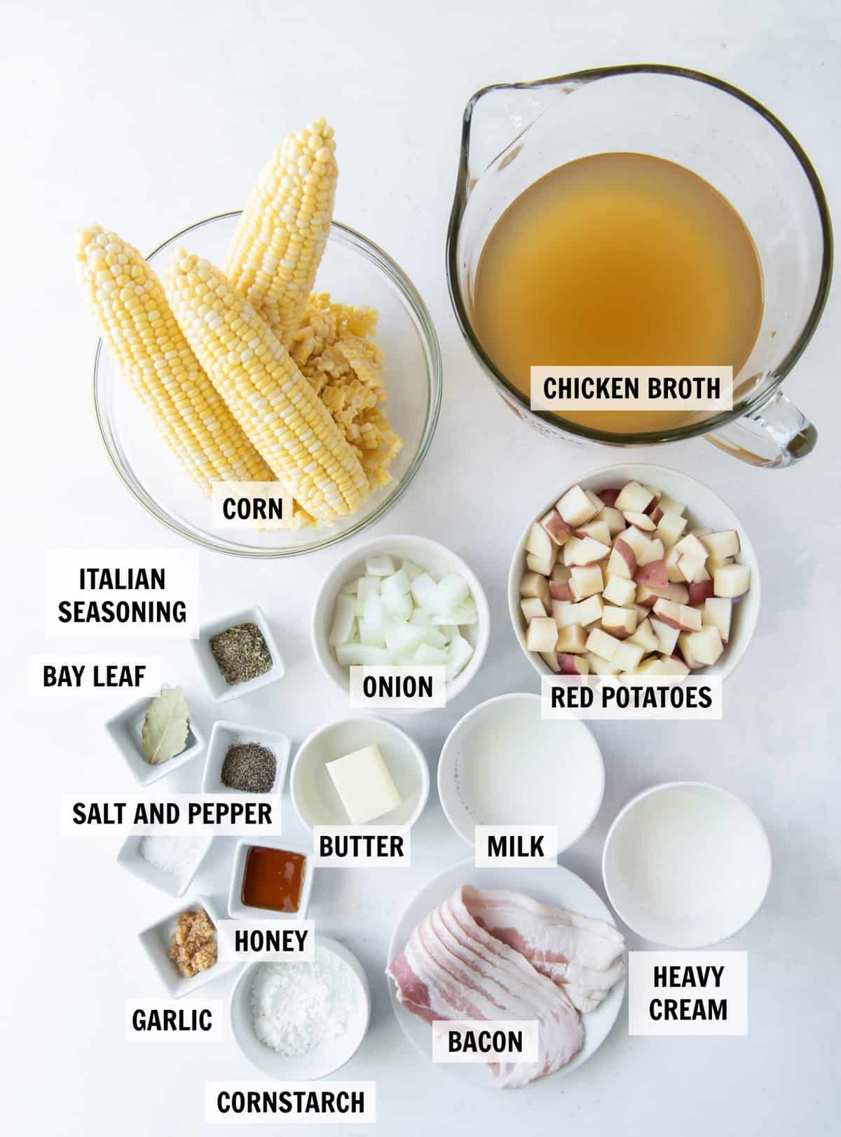 all of the ingredients for corn chowder on a white tabletop