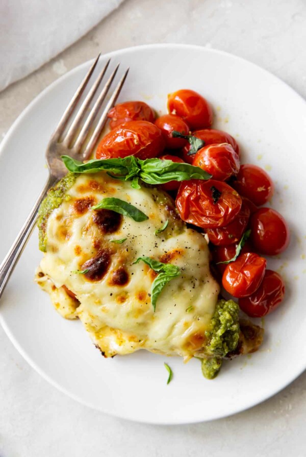 pesto chicken with tomatoes on a plate