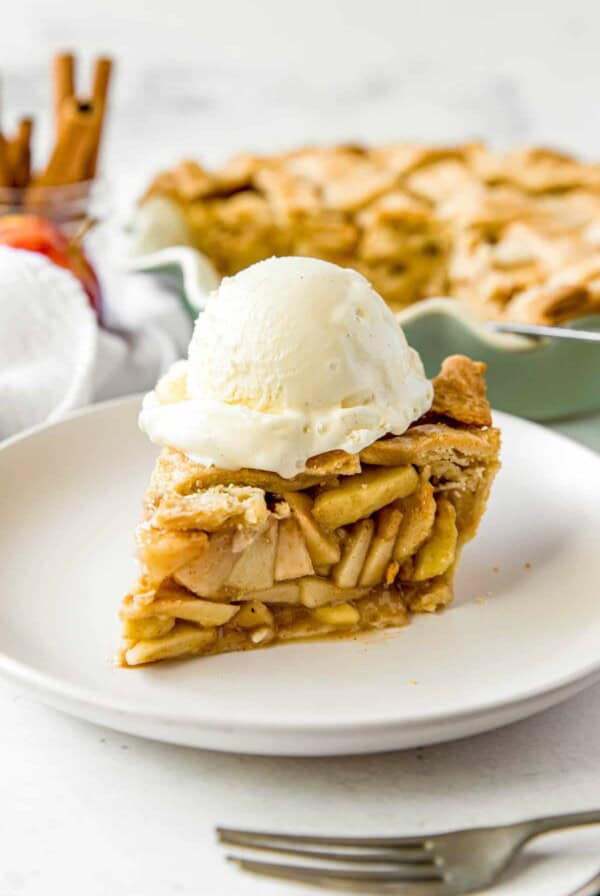 slice of apple pie with a scoop of ice cream on top