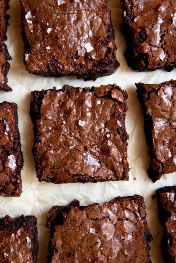 a close up photo of flourless brownies on a piece of parchment paper