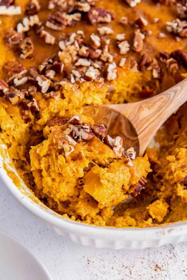 a spoon scooping out sweet potato souffle