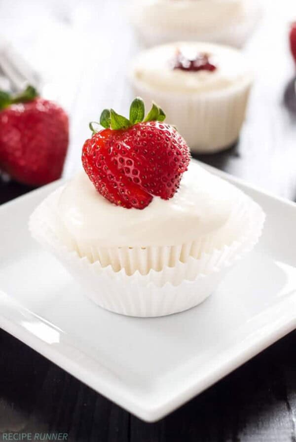 one angel food cupcake with strawberry filling sitting on a white square plate