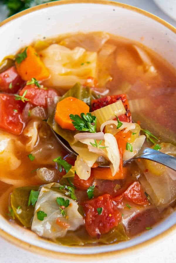 cabbage soup in a bowl with parsley garnish on top