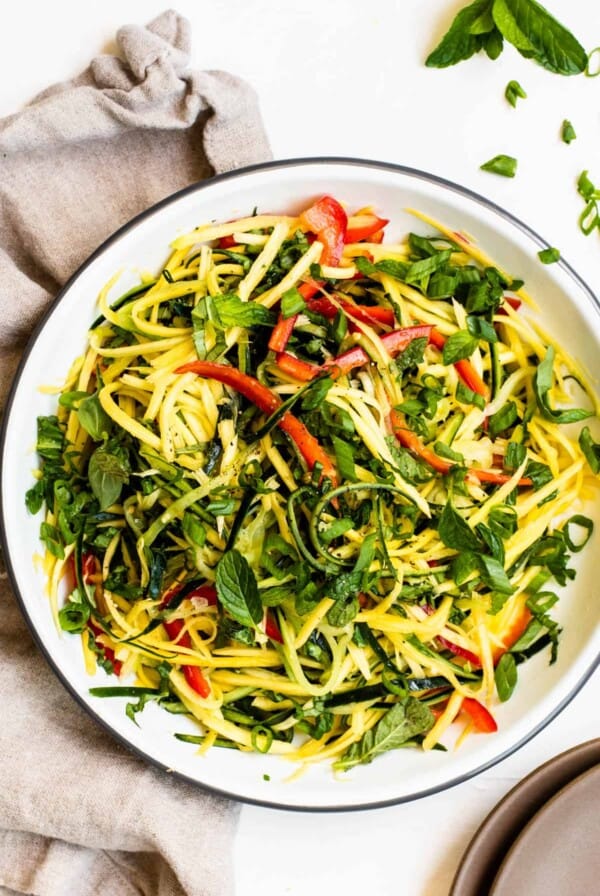 Mango salad with dressing on a plate.