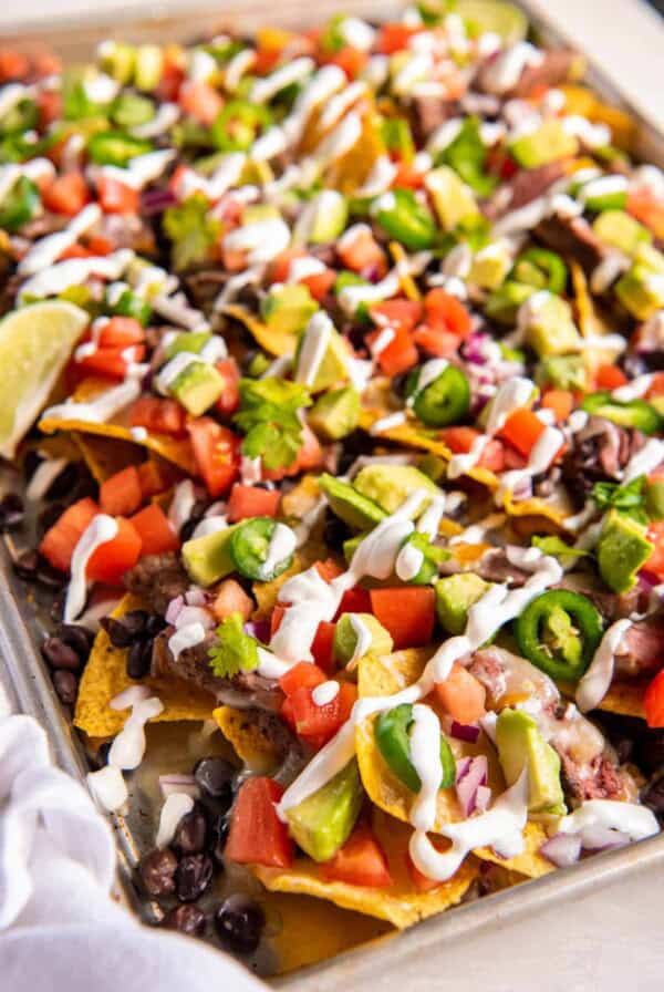 Chips layered with black beans, cooked steak, tomatoes, onions, jalapeno and avocado.