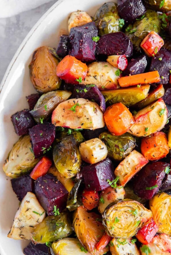 Honey roasted vegetables in a white serving dish ready to be served.